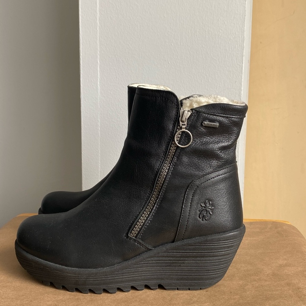 London Fly never worn wedge heel black insulated black bootie with side zipper.